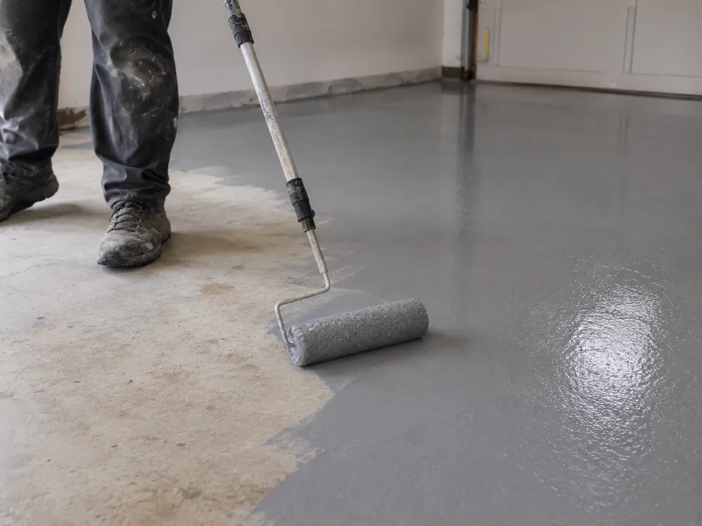 Epoxy coating being applied to seal a concrete surface